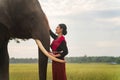 Asian woman and big elephant in the Forest. Elephant with beautiful girl in asian countryside, Surin, Thailand Royalty Free Stock Photo