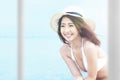 Asian woman with bikini and hat relaxing Royalty Free Stock Photo
