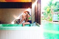 Asian woman in bikini posing on jacuzzi pool in resort. Summer vacation concept. Beauty and summer Royalty Free Stock Photo