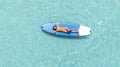 Asian woman in bikini sleep and relax on paddle board on the beach Royalty Free Stock Photo