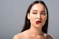 Asian woman biting red lips  on grey Royalty Free Stock Photo