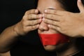 Asian woman blindfold wrapping mouth with red adhesive tape