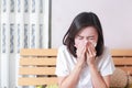 Asian woman blowing her nose while sitting on bed. illness woman Royalty Free Stock Photo