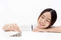 Asian woman with bright smile stacked up the coins - investment, finance, money concept. Royalty Free Stock Photo