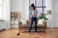 Asian woman with broom sweeping floor and cleaning Royalty Free Stock Photo