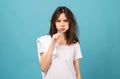 Asian woman brushing teeth and towel on the shoulder on blue background, Concept oral hygiene and health care Royalty Free Stock Photo