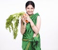 Asian woman with a bunch of carrots Royalty Free Stock Photo