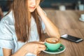 Asian woman in a cafe drinking coffee .Portrait of Asian woman smiling in coffee shop cafe vintage colour tone Royalty Free Stock Photo