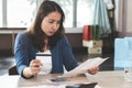 Asian woman calculating monthly expense and credit card debt Royalty Free Stock Photo