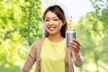 Asian woman with can drink over natural background Royalty Free Stock Photo