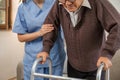 Asian woman caregiver helping senior man walking. Nurse assisting he old man patient at nursing home. Senior man using Royalty Free Stock Photo