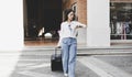 Asian woman carried a suitcase and hurried to her accommodation before her friend`s appointment, Trolley bag, Long weekend travel