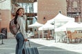 Asian woman carries a suitcase and wears a big hat to prepare for her long weekend trip, Trolley bag, Long weekend travel