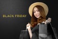 Asian woman carrying a shopping bag with a black background Royalty Free Stock Photo