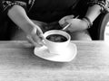 Asian woman catch a glass to drink in coffee shop black and white color tone Royalty Free Stock Photo