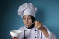 Asian Woman Chef Making Soup, Chef Tasting Soup From White Bowl Royalty Free Stock Photo