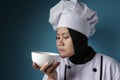 Asian Woman Chef Smelling Food in White Bowl Royalty Free Stock Photo