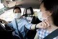 Asian woman,child girl in protective face masks with fastening seat belt in car,mother help care her daughter wear medical mask Royalty Free Stock Photo