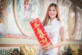 The Asian woman in chinese dress holding couplet 'Lucrative' (C Royalty Free Stock Photo