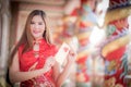 The Asian woman in chinese dress holding couplet 'Lucrative' (C Royalty Free Stock Photo