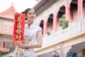 The Asian woman in chinese dress holding couplet 'Lucrative' (C Royalty Free Stock Photo