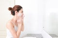 Asian woman cleaning face skin enjoy herself with bubble cleansing foam. Royalty Free Stock Photo