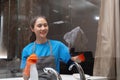 Asian woman cleaning the glass in the apartment. Cleaning staff maintain cleanliness in with towel and spray detergent