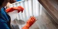 Asian woman cleaning the glass table in the apartment. Cleaning staff maintain cleanliness in with towel and spray