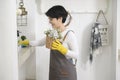 Asian woman with cleaning gloves using alcohol spray sanitiser to cleaning house, healthy lifestyle concept Royalty Free Stock Photo