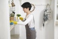 Asian woman with cleaning gloves using alcohol spray sanitiser to cleaning house, healthy lifestyle concept Royalty Free Stock Photo