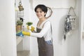 Asian woman with cleaning gloves using alcohol spray sanitiser to cleaning house, healthy lifestyle concept Royalty Free Stock Photo