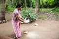 Asian woman clearing rice