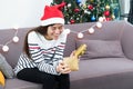 Asian woman close eye when open gold xmas gift box at holiday pa