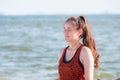 Asian woman close eyes and doing meditation yoga pose at coastline beach, Calm and relax concept,wellness and healthy lifestyle. Royalty Free Stock Photo