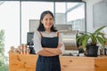 Asian woman coffee shop employee barista working at cafe. Smiling female waitress cashier. Small business owner and part Royalty Free Stock Photo