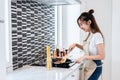 Asian woman cooking spaghetti in kitchen happily. People and lifestyles concept. Food and drink theme. Interior decoration and ho