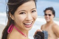 Asian Woman Couple at Beach Taking Video or Photograph Royalty Free Stock Photo