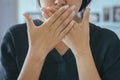 Asian woman covering her mouth and smell her breath with hands upter wake up,Bad smell