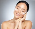 Asian woman, cream and skincare for wellness, natural beauty and healthy with cosmetics in studio background Royalty Free Stock Photo
