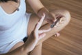 Asian woman cutting nails with using nail clipper