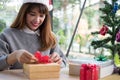 Woman decorate xmas gift box with ribbon. season greetings for w Royalty Free Stock Photo