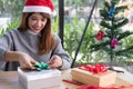 Woman decorate xmas gift box with ribbon. season greetings for w Royalty Free Stock Photo