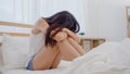 Asian woman depression feeling sad lying on bed in bedroom, Beautiful japanese female tired upset bad mood at home. Lifestyle Royalty Free Stock Photo