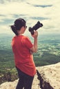 Asian woman with digital camera, outdoor at the daytime on summer day. Royalty Free Stock Photo