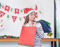 Asian woman disappointed about payment when buy a lot of christmas gift in shopping bags,upset expenses after shopping