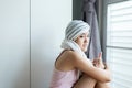 Asian woman with disease cancer is showing thumb up and sitting in bedroom,Positive thinking,Good attitude Royalty Free Stock Photo