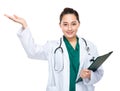 Asian woman doctor present with clipboard