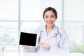 Asian woman doctor showing digital tablet screen Royalty Free Stock Photo