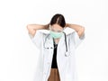 Asian woman doctor wearing green medical face mask, face shield and white coat with stethoscope. Portrait of young attractive Royalty Free Stock Photo