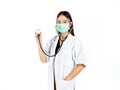 Asian woman doctor wearing green medical face mask, face shield and white coat with stethoscope. Portrait of young attractive Royalty Free Stock Photo